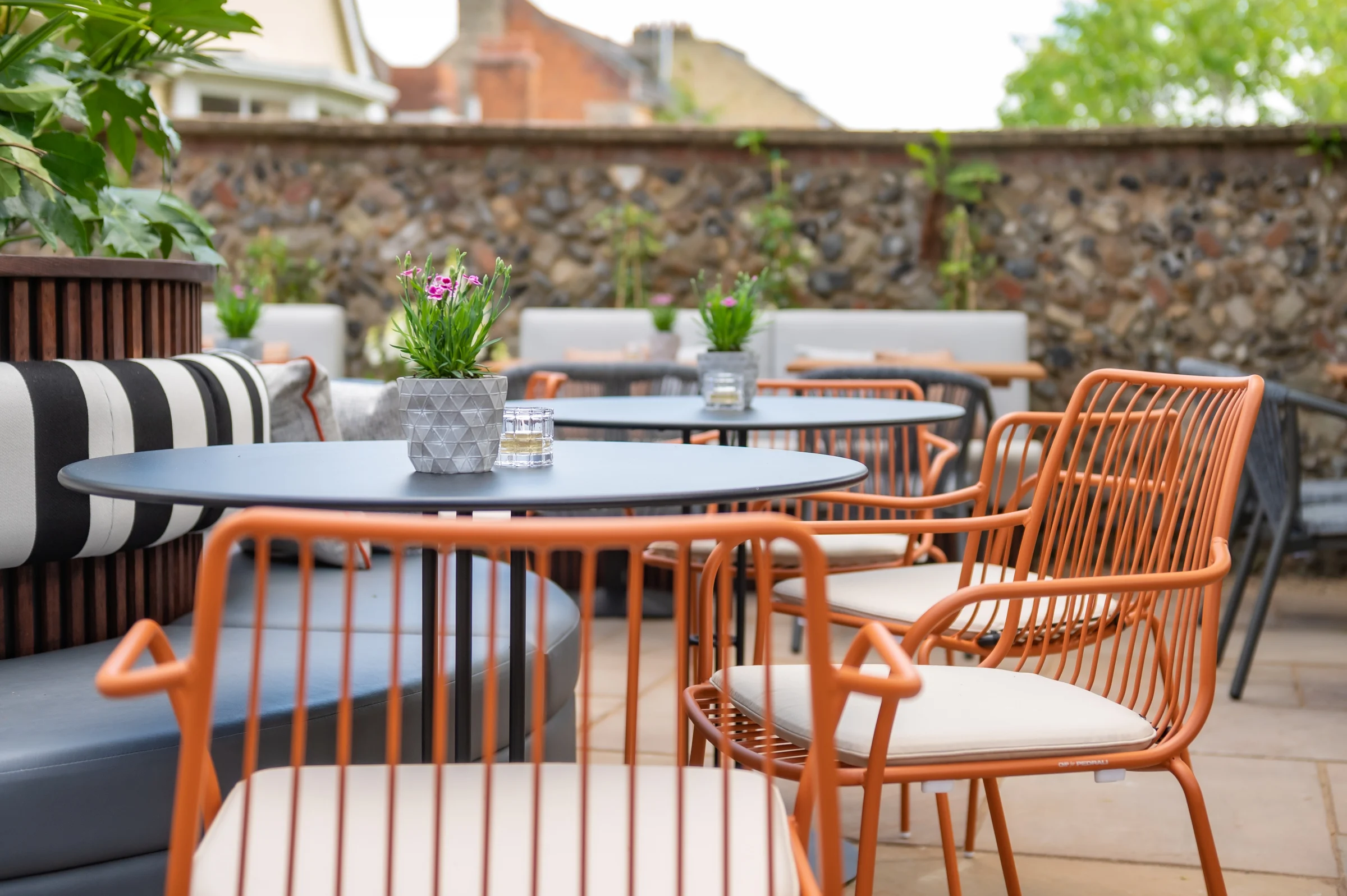 Garden tables and orange chairs on the terrace