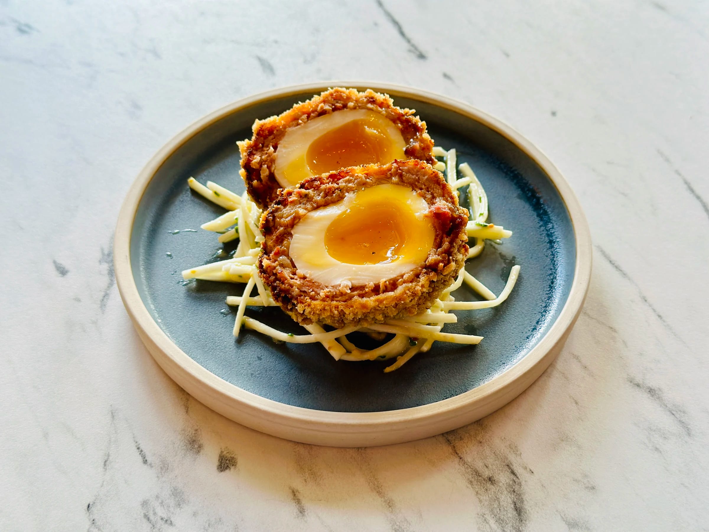 Scotch egg on a blue plate